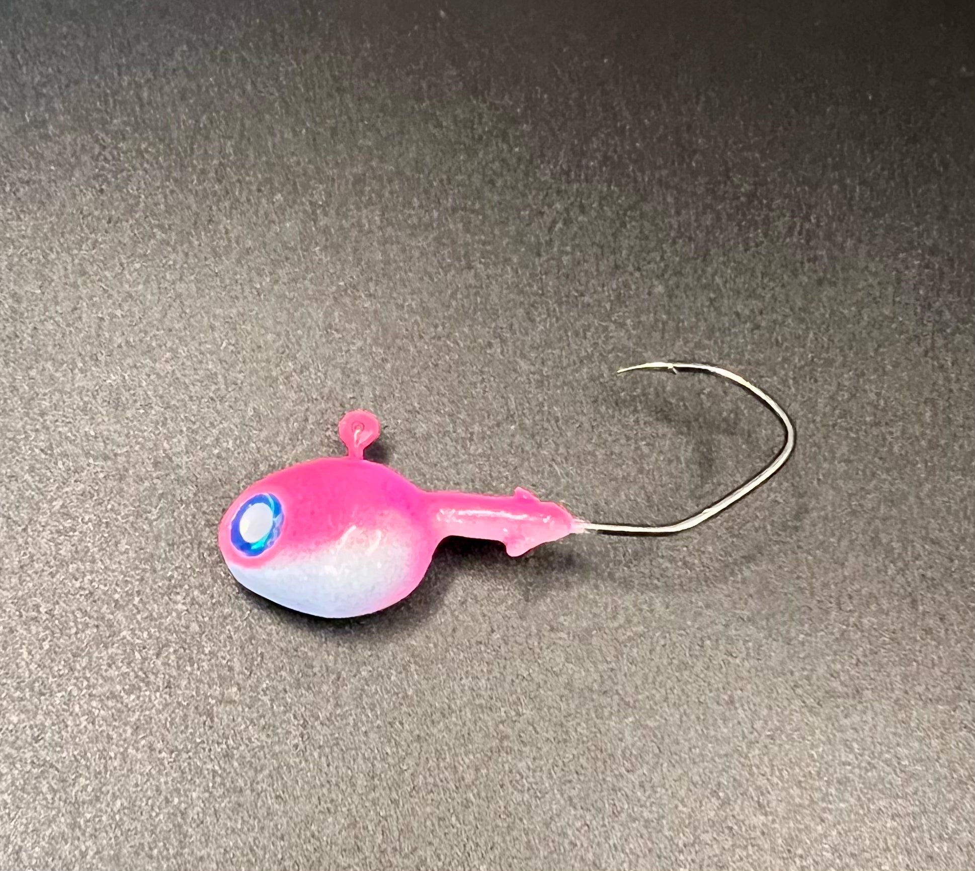 Pink and white walleye jig with blue eye and hook