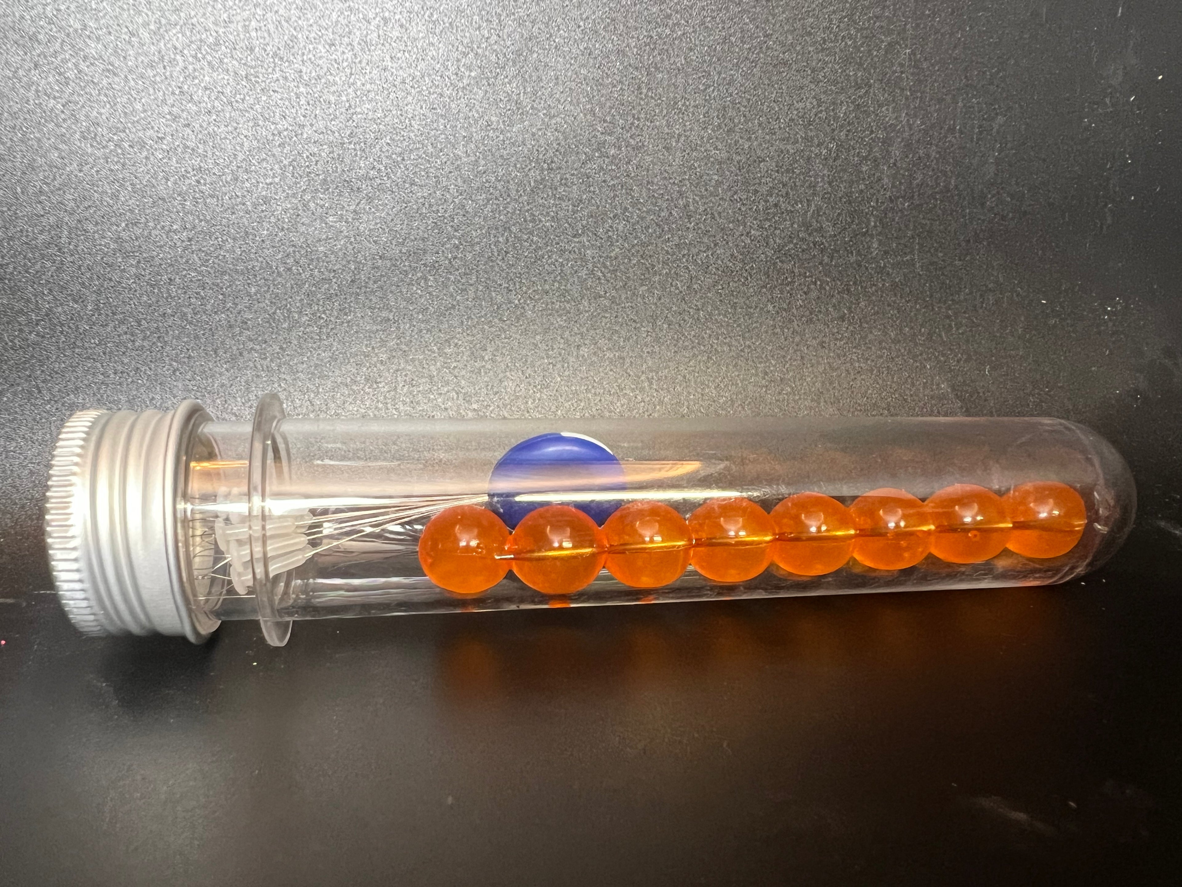 Clear tube of orange soft plastic beads for salmon & steelhead fishing