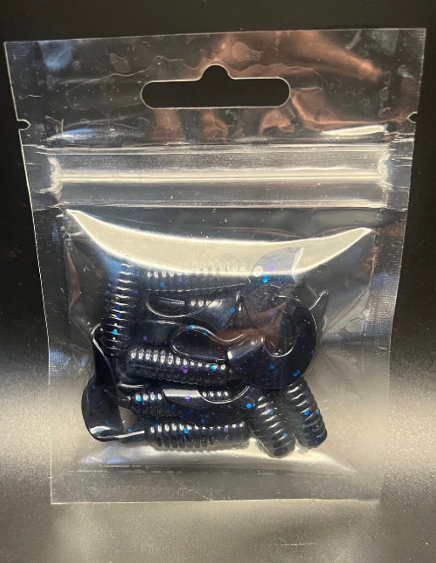 Soft plastic stickbait worms in dark blue with purple highlights inside clear pack