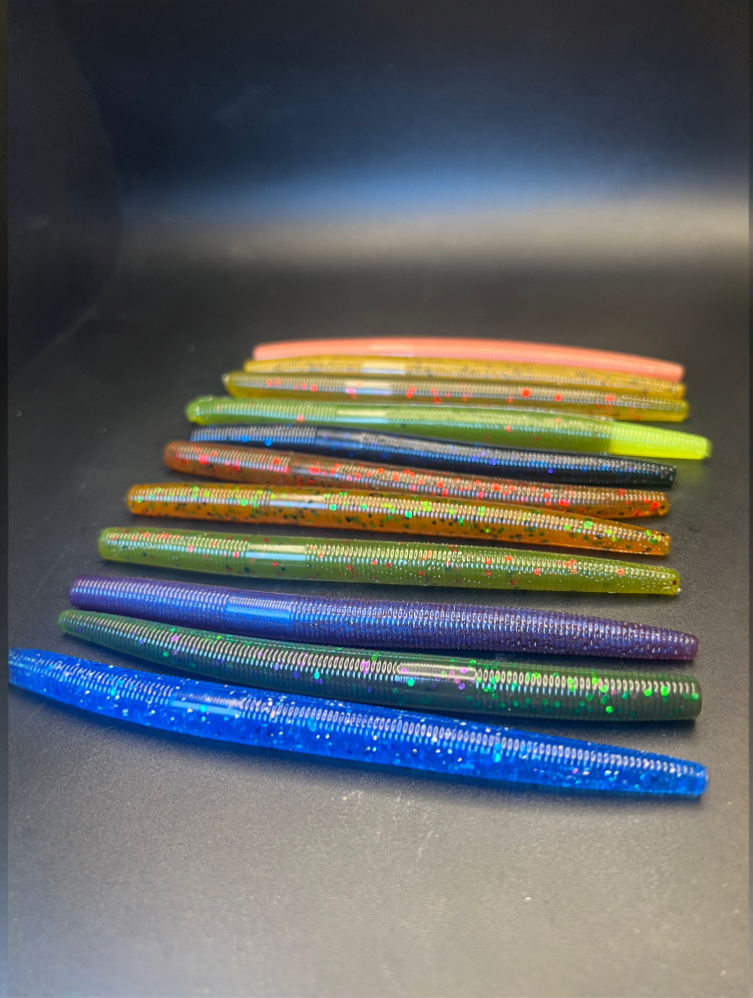 Assorted soft plastic stickbait worms, blue-purple-green with speckled dots