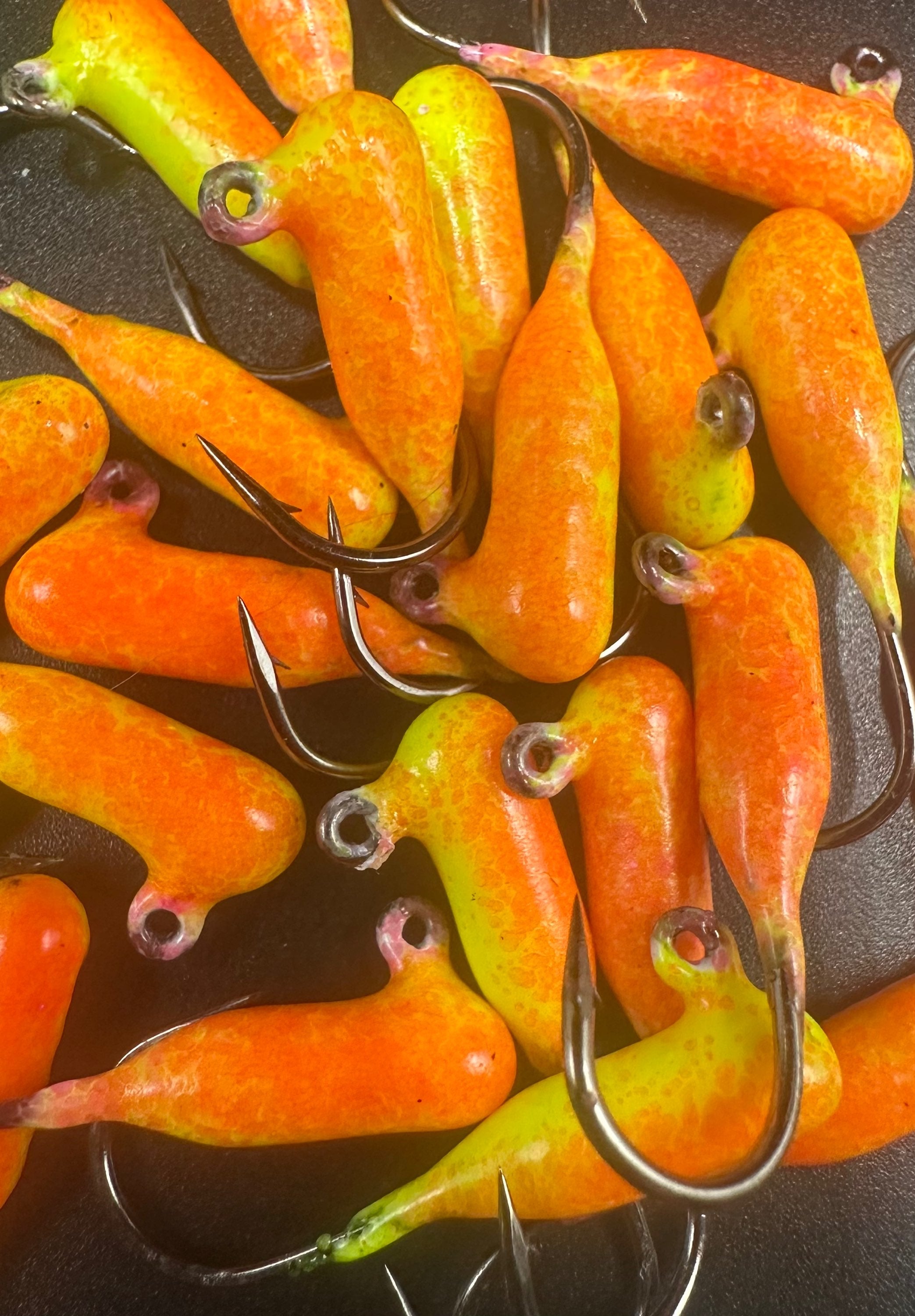 Orange/green tube jigs with hooks from Lava Indestructible Paint Series