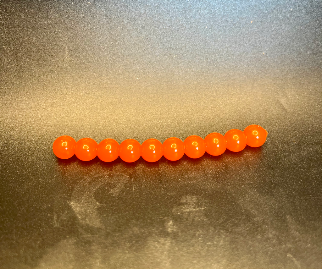 Orange soft plastic roe beads for fishing, line of beads