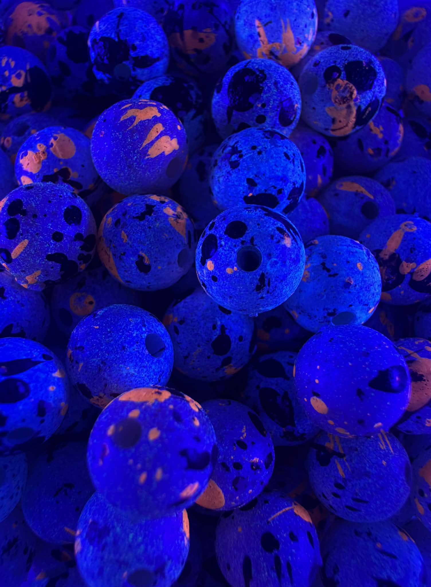 UV glow blue fishing beads with speckled pattern and round center holes