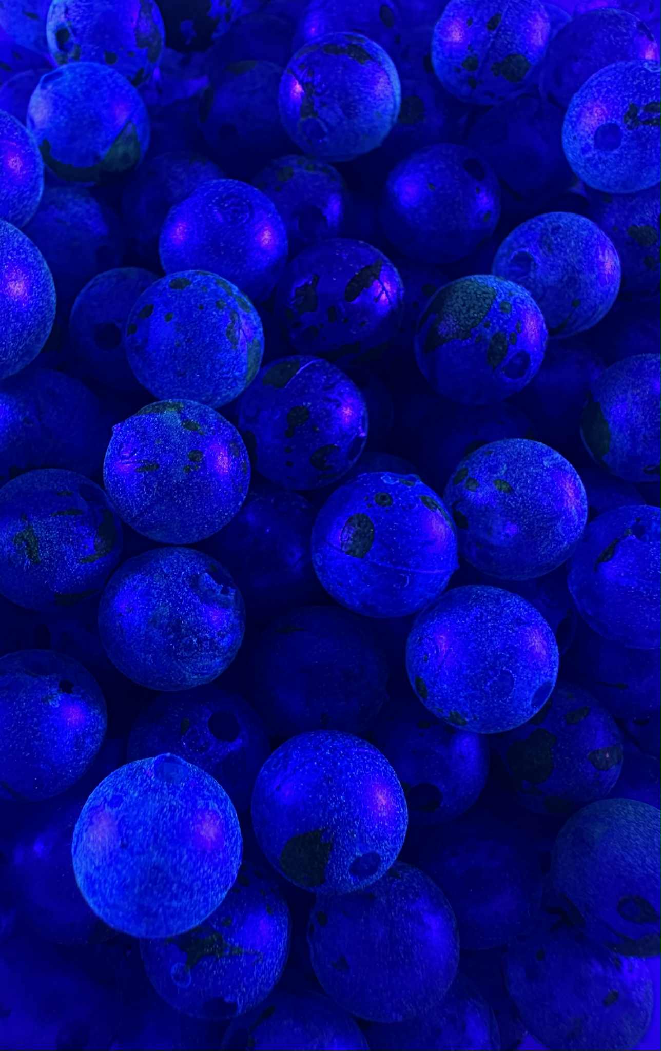 Lemon Berry UV glow fishing beads, blue glowing spheres with dark specks