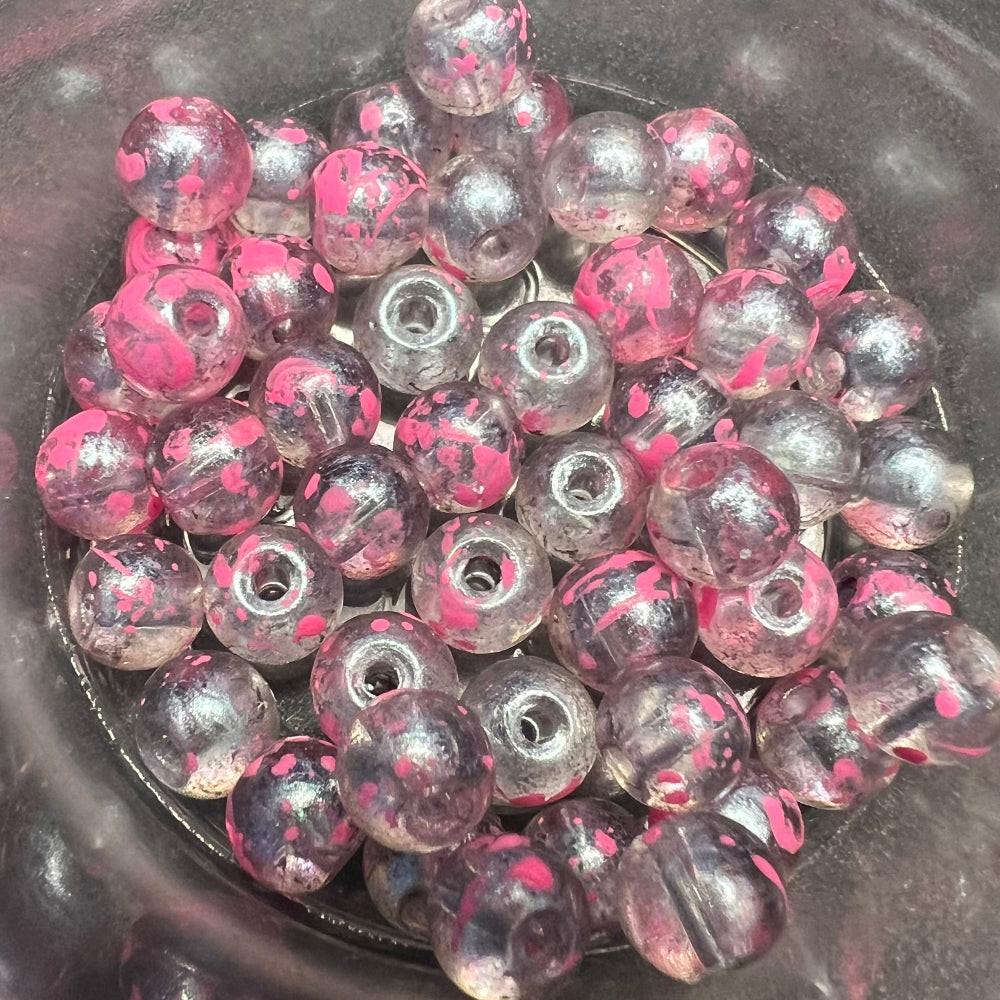 Pink-and-silver glass fishing beads with metal eyelets for steelhead rigs