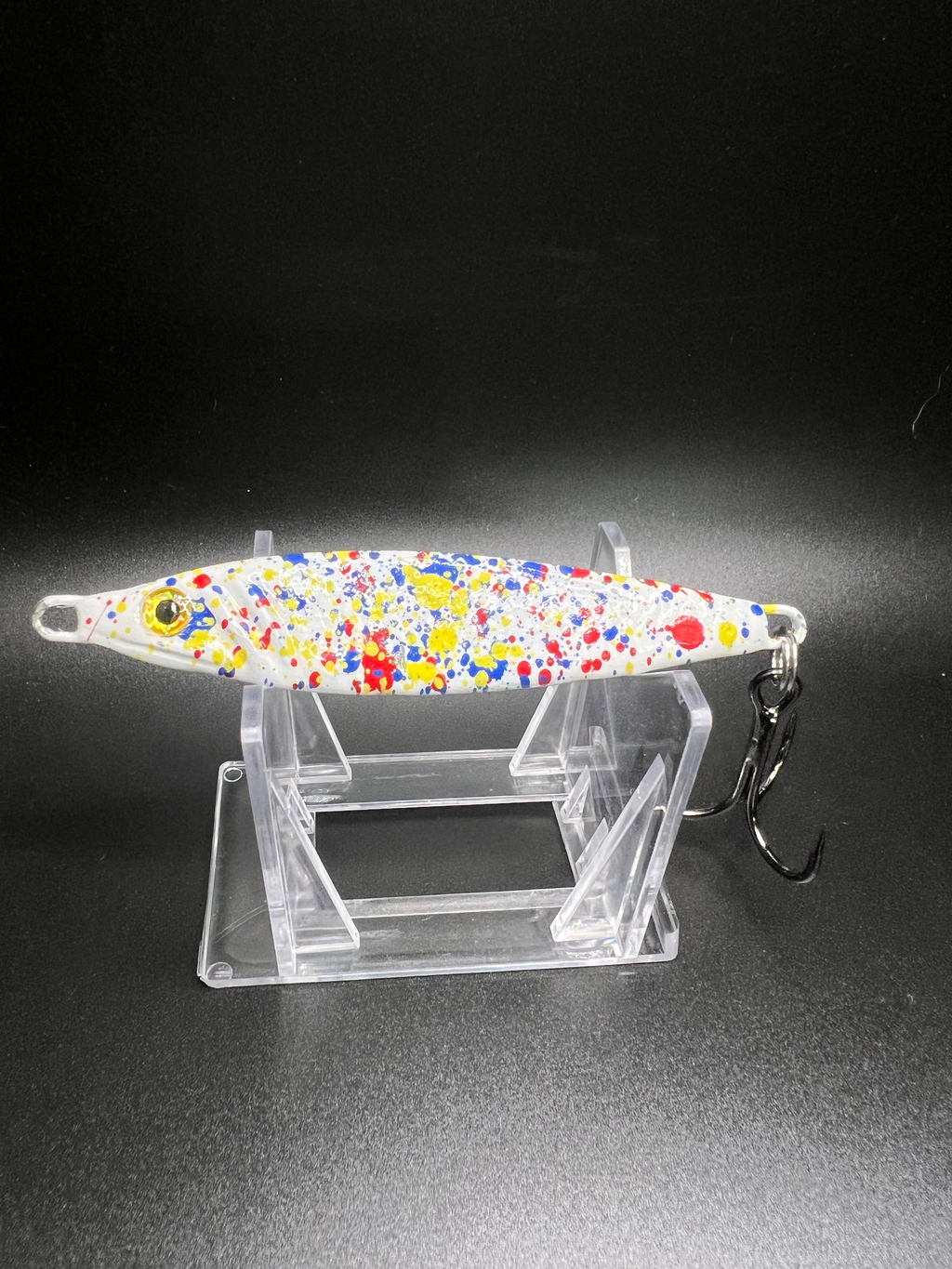 UV Glow jigging spoon, white with colorful speckle pattern and treble hook
