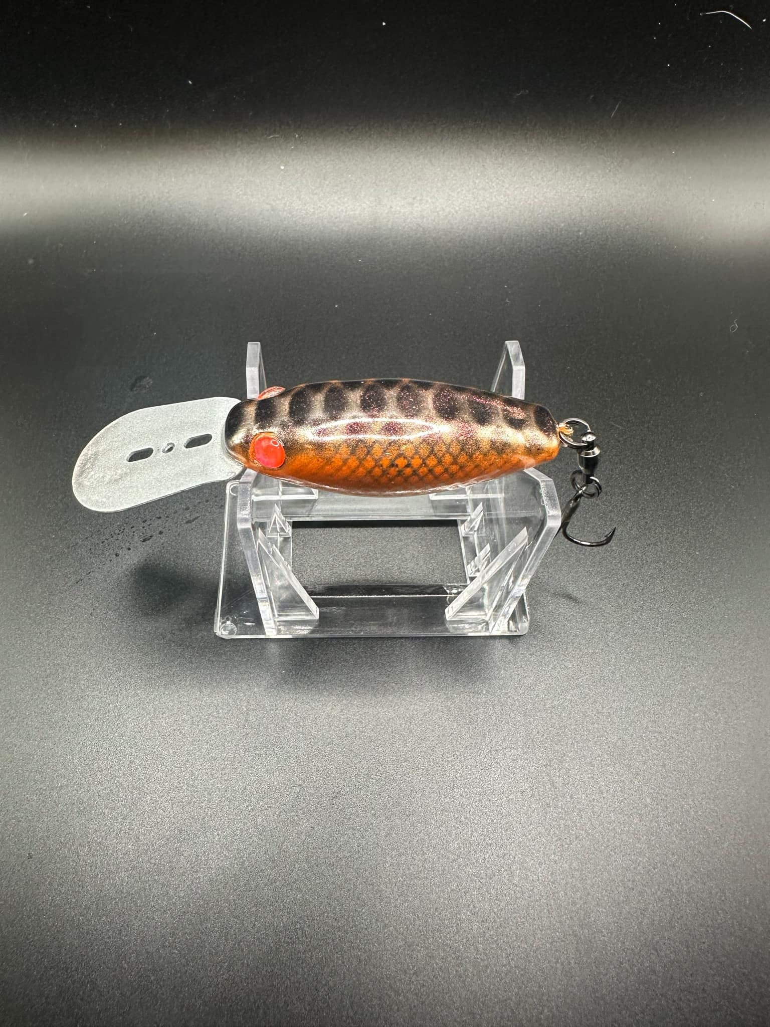 Orange Chromesicle crankbait style lure, patterned back, red eye and silver lip