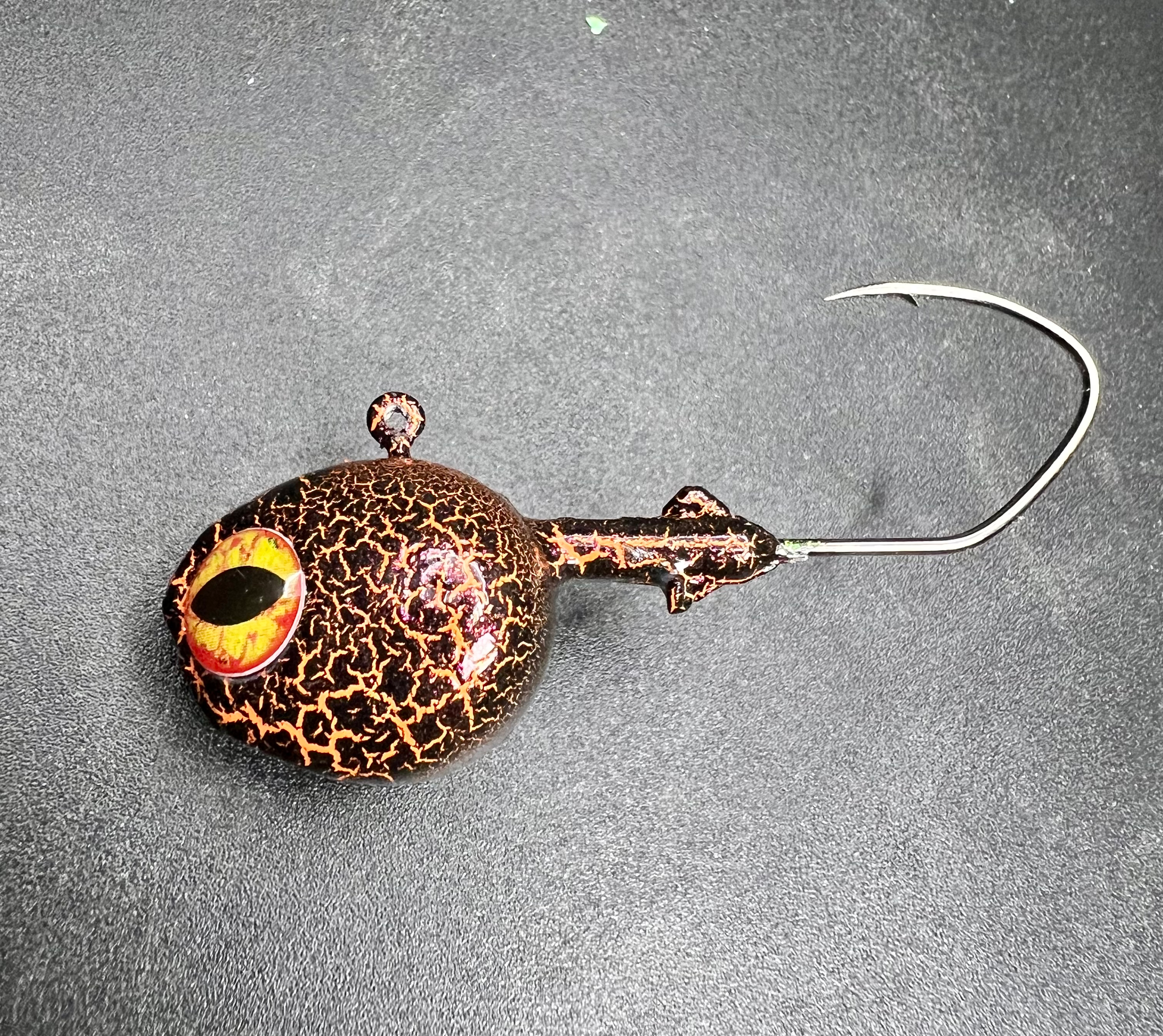 Salamander walleye jig in dark copper with orange eye, tied to metal hook
