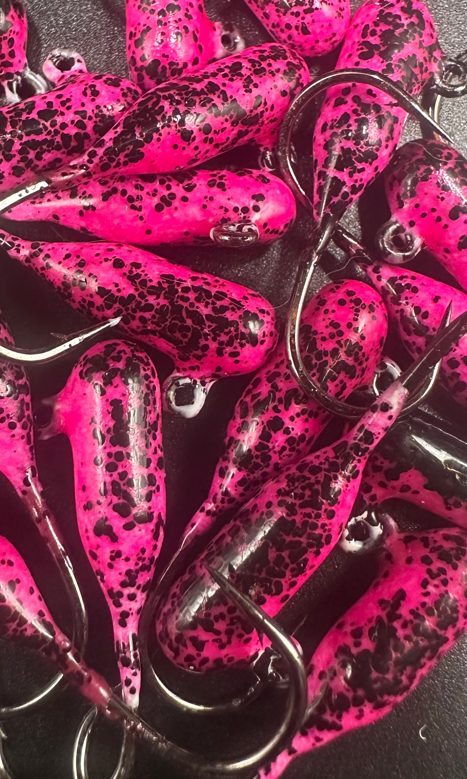 Pink and black speckled tube jigs in steelhead hook style