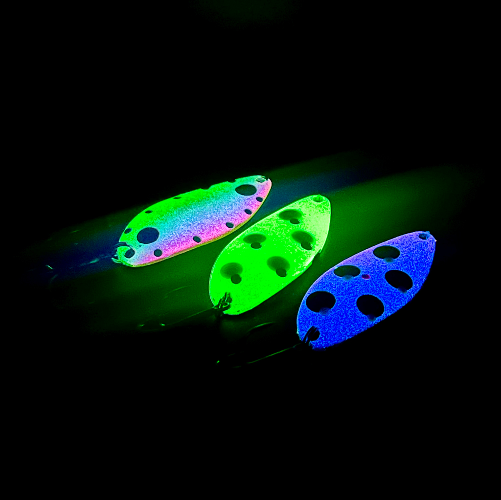 Glow lures: green, neon-blue, and greenish-pink spoon with dot holes (treble hooks)