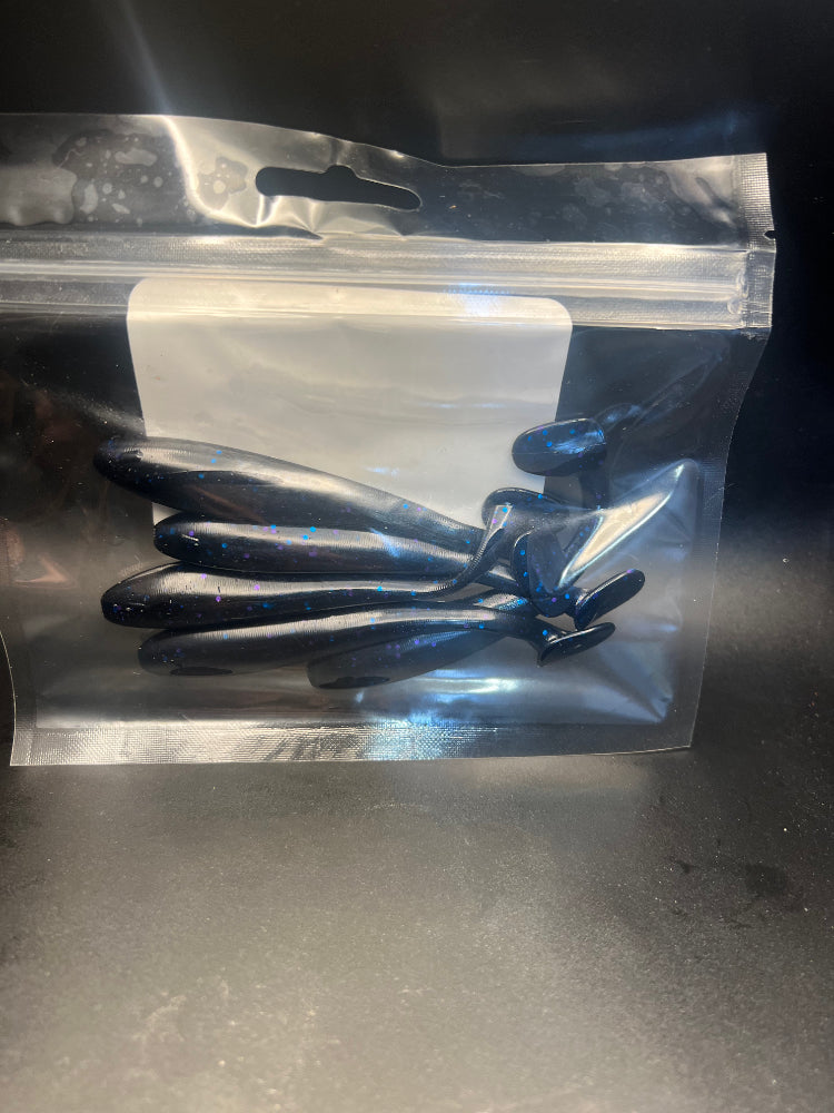 Dark blue speckled paddle tail swimbaits in retail bag