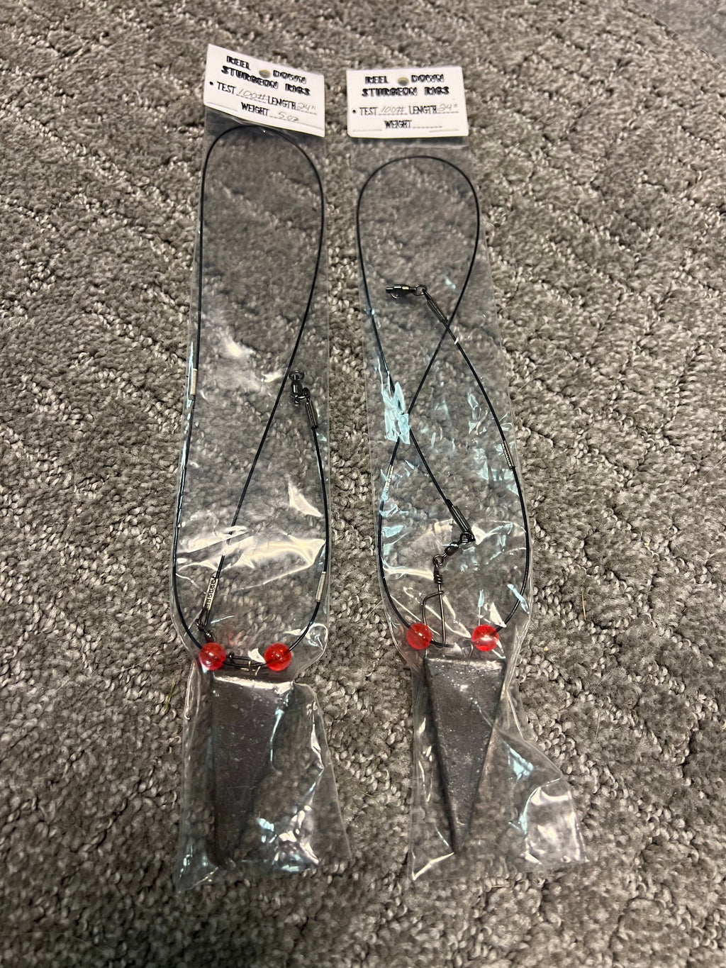 Two 100 lb sturgeon rigs with red beads and clear leader, blue bait cones