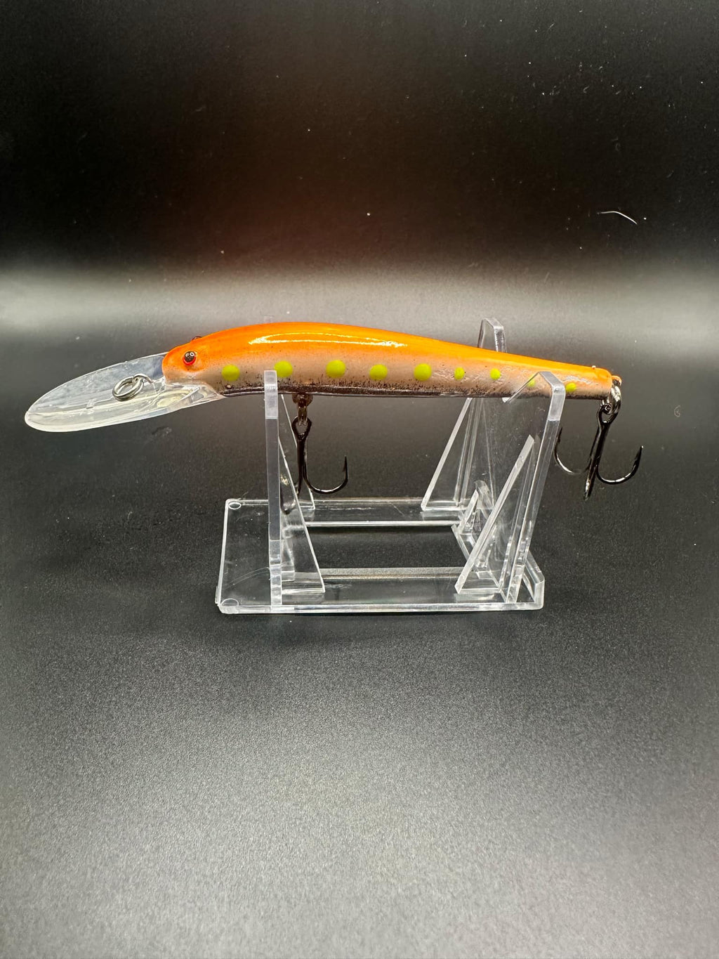 Orange Lightningstick lure with clear lip, chartreuse dots, 3X strong treble hooks
