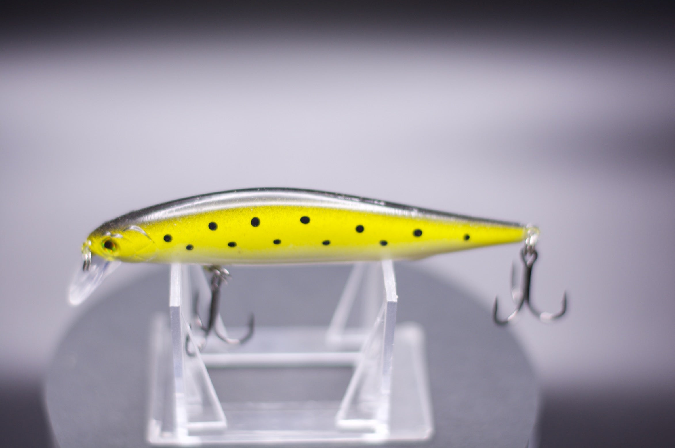 Yellow jerk bait with black dot pattern and two treble hooks, 1/2 oz