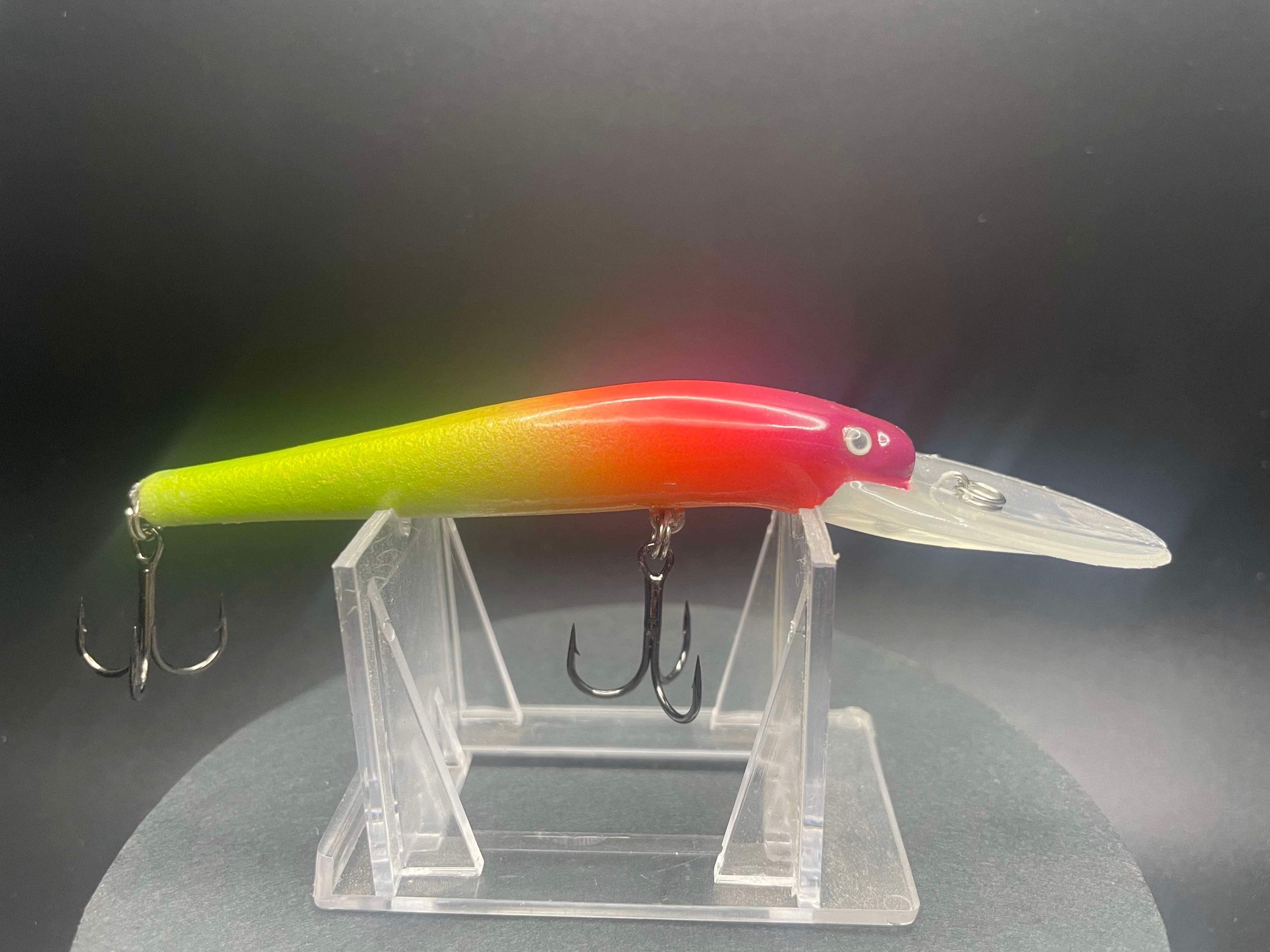 UV Glow Lightningstick lure, neon yellow-green to pink-red body, with treble hooks