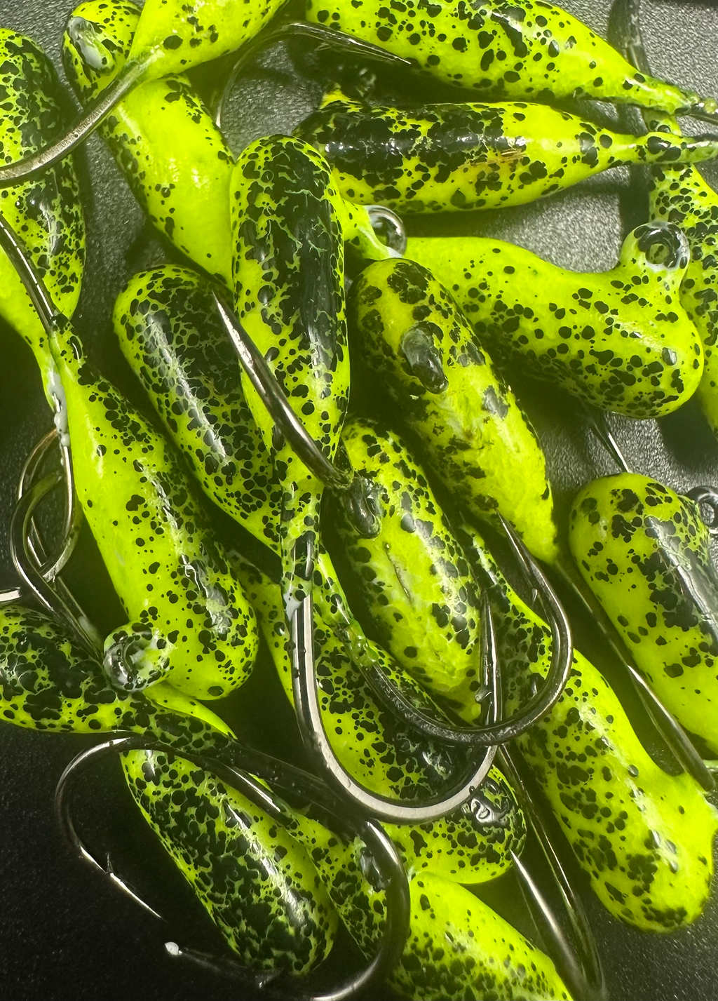 Lemon Pepper steelhead tube jigs in neon yellow-green with black speckles and hooks