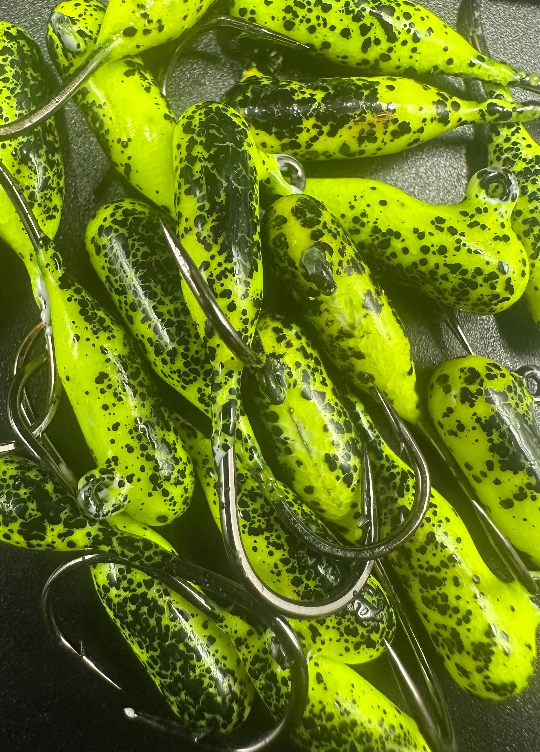 Lemon Pepper steelhead tube jigs in neon yellow-green with black speckles and hooks